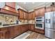 Modern kitchen with stainless steel appliances, granite countertops, and custom wood cabinets at 15254 Kampen Cir, Carmel, IN 46033