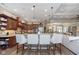 Open kitchen with granite countertops, modern appliances, island with bar seating, and seamless access to the living room at 15254 Kampen Cir, Carmel, IN 46033