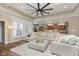 Bright living room with large windows, a comfortable sectional, and hardwood floors at 15254 Kampen Cir, Carmel, IN 46033