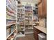 Well-stocked pantry with ample shelving, organized storage containers, and a variety of food items at 15254 Kampen Cir, Carmel, IN 46033