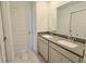 Bathroom featuring dual sinks with grey countertops and a well-lit vanity area at 15925 Cobbs Crk Ln, Noblesville, IN 46060