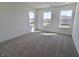 Bright bedroom featuring a large window, neutral carpet, and plenty of open space at 15925 Cobbs Crk Ln, Noblesville, IN 46060