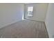 Bright bedroom featuring neutral carpet flooring and a large window with natural light at 15925 Cobbs Crk Ln, Noblesville, IN 46060