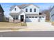 Charming two-story home with a three-car garage and manicured lawn at 15925 Cobbs Crk Ln, Noblesville, IN 46060