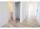 Bright hallway with vinyl floors leads to a storage closet and bathroom at 15925 Cobbs Crk Ln, Noblesville, IN 46060