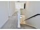 Upstairs hallway featuring carpet, open floor plan, and a wooden railing at 15925 Cobbs Crk Ln, Noblesville, IN 46060