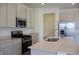 Kitchen features stone countertops, modern stainless steel appliances and bright white cabinets at 15925 Cobbs Crk Ln, Noblesville, IN 46060