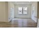 Bright living room with vinyl plank floors and view of the lush backyard at 15925 Cobbs Crk Ln, Noblesville, IN 46060