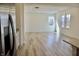 Open living room with luxury vinyl plank floors and view of the kitchen at 15925 Cobbs Crk Ln, Noblesville, IN 46060