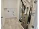 Well-lit utility room with modern tile flooring and essential appliances for convenience at 15925 Cobbs Crk Ln, Noblesville, IN 46060