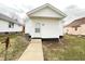 Back exterior view featuring new siding and a small walkway at 1640 W 7Th St, Anderson, IN 46016