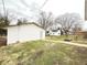 Spacious backyard featuring a garage with a concrete walkway at 1640 W 7Th St, Anderson, IN 46016