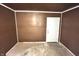 View of the basement with brown walls, white trim, and concrete floors at 1640 W 7Th St, Anderson, IN 46016