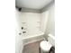 Updated bathroom featuring a shower-tub combination, white fixtures, and sleek black hardware at 1640 W 7Th St, Anderson, IN 46016