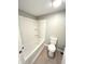 Clean and bright bathroom with a shower-tub combination, toilet, and neutral finishes at 1640 W 7Th St, Anderson, IN 46016