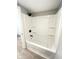 Bathroom featuring a white shower-tub combination with built-in shelving at 1640 W 7Th St, Anderson, IN 46016