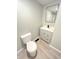 Bathroom featuring a vanity with sink, toilet, and a framed mirror at 1640 W 7Th St, Anderson, IN 46016