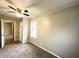 Bedroom featuring neutral walls, carpet, window, door, and ceiling fan at 1640 W 7Th St, Anderson, IN 46016