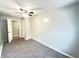 Bedroom with carpet, a ceiling fan, and views into an adjacent room through an open door at 1640 W 7Th St, Anderson, IN 46016