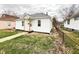 Quaint one-story home with white siding and a small front porch in a residential neighborhood at 1640 W 7Th St, Anderson, IN 46016