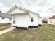Corner view of home showing a white door with a white exterior at 1640 W 7Th St, Anderson, IN 46016