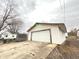 Angled view of white detached garage with concrete driveway at 1640 W 7Th St, Anderson, IN 46016