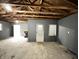 Unfinished garage interior with open beams and concrete floor at 1640 W 7Th St, Anderson, IN 46016