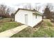 Exterior of detached garage featuring new siding, walk way, and small window at 1640 W 7Th St, Anderson, IN 46016