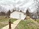 Exterior of detached garage featuring new siding and small walkway at 1640 W 7Th St, Anderson, IN 46016
