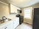 Updated kitchen with white cabinets, black appliances, modern hardware, and a window for natural light at 1640 W 7Th St, Anderson, IN 46016