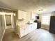 Modern kitchen featuring new cabinets, updated appliances, and stylish flooring at 1640 W 7Th St, Anderson, IN 46016
