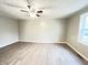 Neutral room featuring modern flooring, ceiling fan, and a view of a bright window at 1640 W 7Th St, Anderson, IN 46016