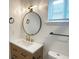 Chic bathroom with vanity, modern fixtures, round mirror, and natural lighting at 1716 E Kelly St, Indianapolis, IN 46203