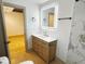 Bright bathroom with modern light fixture, vanity, and marble accent wall at 1716 E Kelly St, Indianapolis, IN 46203