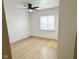 A bright bedroom features hardwood flooring and a ceiling fan at 1716 E Kelly St, Indianapolis, IN 46203