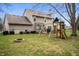 Backyard with swing set, fire pit, grassy lawn and view of the home's exterior at 17918 Lucas Cir, Westfield, IN 46074