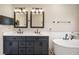 Luxurious bathroom featuring double vanities, a soaking tub, and modern fixtures at 17918 Lucas Cir, Westfield, IN 46074