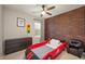 Fun bedroom with unique race car bed and brick accent wall at 17918 Lucas Cir, Westfield, IN 46074