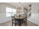 Bright dining room featuring wood floors, modern lighting, and window overlooking the neighborhood at 17918 Lucas Cir, Westfield, IN 46074