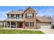 Charming two-story home with a brick facade, covered porch, and well-maintained lawn at 17918 Lucas Cir, Westfield, IN 46074