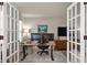 Spacious home office with french doors, modern desk, and ample natural light at 17918 Lucas Cir, Westfield, IN 46074