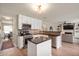 Open kitchen with white cabinets, stainless steel appliances, and black granite countertops at 17918 Lucas Cir, Westfield, IN 46074