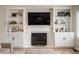 Stylish living room with a fireplace, built-in shelving, and modern decor accents at 17918 Lucas Cir, Westfield, IN 46074