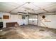 An empty garage with a concrete floor, a dart board, and white painted walls at 1821 E Stop 10 Rd, Indianapolis, IN 46227