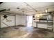 An empty garage with a concrete floor, a dart board, and white painted walls at 1821 E Stop 10 Rd, Indianapolis, IN 46227