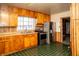 Well-lit kitchen with stainless steel appliances and wood cabinets at 1821 E Stop 10 Rd, Indianapolis, IN 46227