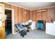 Laundry room with washer, dryer, wood-paneled walls, and access to kitchen at 1821 E Stop 10 Rd, Indianapolis, IN 46227