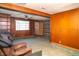 Comfortable living room with wood paneling, view to adjacent room, and ceiling fan at 1821 E Stop 10 Rd, Indianapolis, IN 46227