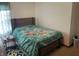 Comfortable bedroom featuring a stylish bed with a unique patterned bedspread and flooring at 1835 Carpenter Cir, Indianapolis, IN 46203