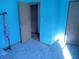 A simple bedroom with an open doorway, light blue walls, and blue tile floors at 1835 Carpenter Cir, Indianapolis, IN 46203
